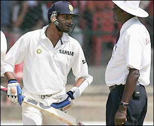 Harbhajan Singh discusses the game with West Indian umpire Steve Bucknor