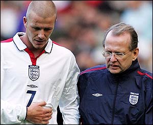 Beckham clutches his rib