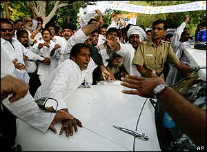 Supporters of the Congress party president beat on the man tipped as a possible PM, Manmohan Singh.