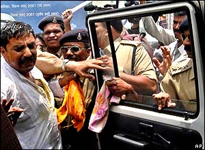Police detain Pramod Chugh, left, an activist of the Hindu nationalist party Shiv Sena after he tried to self-immolation in Bhopal.