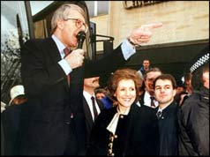 John Major on soapbox with Norma in crowd beside him 