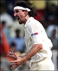 Jason Gillespie celebrates bowling VVS Laxman