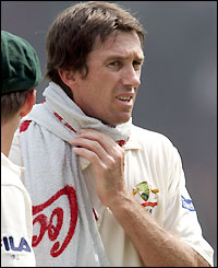 Veteran bowler Glenn McGrath enjoys the effects of a wet towel during a break in play
