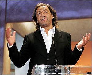 Tony Gatlif accepts the award for best director for his film Exiles