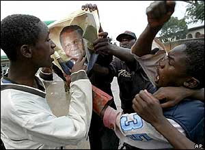 Youths ripping up a Mutharika poster