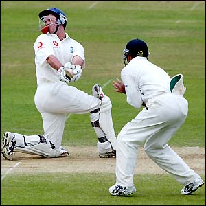 The ball is lodged in the helmet of Andrew Strauss as he tries to play a sweep shot