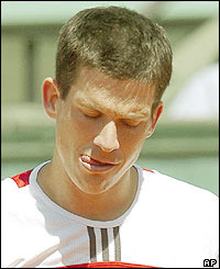 Tim Henman fights back from two sets down to beat Cyril Saulnier 