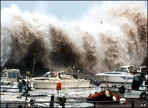 A billow caused by Typhoon Tokage clashes against a seawall in a harbour in Beppu, Oita Prefecture, south-western Japan, Wednesday morning, Oct. 20, 2004. 