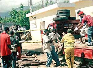 Flood victims are loaded onto a truck by civil defence workers