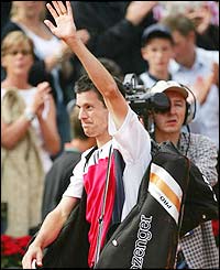 Tim Henman celebrates victory after coming from two sets down against French wild card Michael Llodra