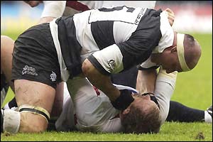 Mark Andrews of the Barbarians tussles with England captain Hugh Vyvyan
