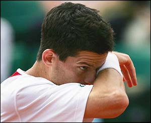 Tim Henman wipes sweat from his brow