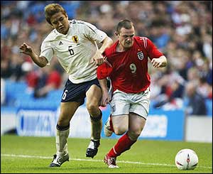 Junichi Inamoto challenges England's Wayne Rooney