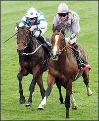 Screwdriver ridden by jockey Richard Hughes (right) wins ahead of Royal Island ridden by jockey Keith Dalgleish in the Vodafone Woodcote Stakes