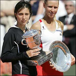 Myskina holds the trophy after completing a comprehensive win over her childhood friend from Moscow