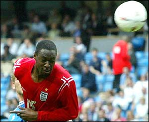 Ledley King heads at goal