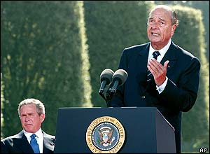 French President Jacques Chirac delivers his speech as U.S. President George W. Bush, left, listens on during a ceremony at the American Cemetery