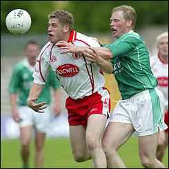 Liam McBarron moves in to challenge Kevin Hughes