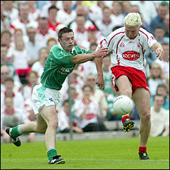 Fermanagh's Hugh Brady moves in on Tyrone forward Owen Mulligan