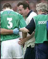 Fermanagh manager Charlie Mulgrew checks on the fitness of Barry Owens