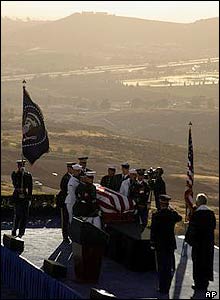 A military honour guard places the Reagan's casket onto the bier during the internment ceremony
