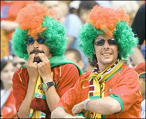 Prtugal fans wear wigs at the match with Greece