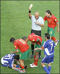 Referee Pierluigi Collina books Portugal's Costinha