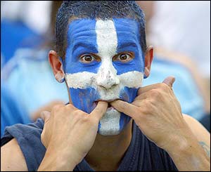 A Greece fan whistles during his side's match with Portugal