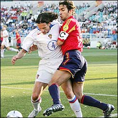 Russian midfielder Yevgeny Aldonin and Spanish defender Ivan Helguera grapple for the ball 