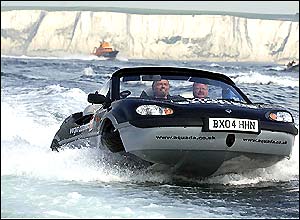 Sir Richard Branson and Neil Jenkins travel past the White Cliffs of Dover in an Aquada