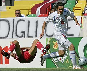 Czech Republic defender Marek Jankulovski breaks a tackle by Latvia's Verpakovskis