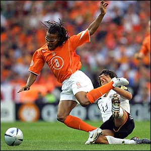 Michael Ballack is given a stern talking to by the referee after a clumsy tackle