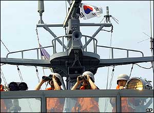South Korean Navy sailors on a warship send flash signals to a North Korean warship on the western maritime border near Yeonpyeong Island, South Korea, Monday, June 14, 2004