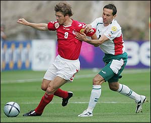 Denmark's Thomas Helveg is challenged by Martin Petrov