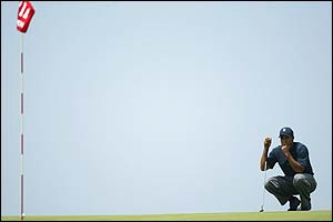 Tiger Woods assesses a putt on the 11th green