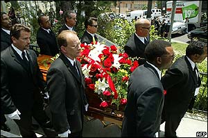 Pallbearers carry the casket 
