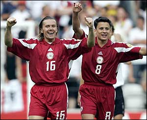 Latvia's Dzintars Zimis and Imants Bleidelis celebrate