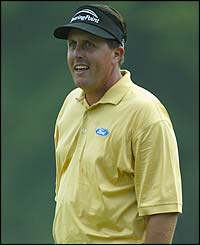 Phil Mickelson celebrates holing a putt