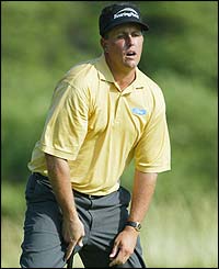 Mickelson reacts to a missed putt