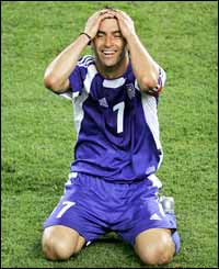Greece skipper Theo Zagorakis drops to his knees in joy at the full-time whistle 