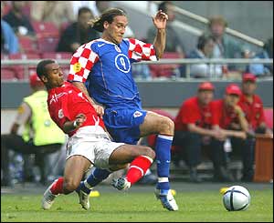 Dado Prso dribbles past England's Ashley Cole
