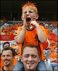 Dutch fans shout encouragement as the team appear on the pitch
