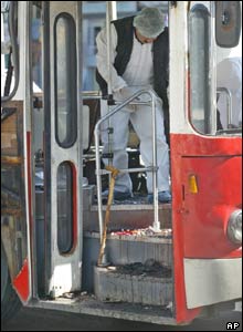 Police officer examines the scene of the bus blast in Istanbul