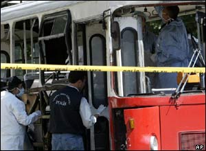 Police officers examine the scene of a bombing on a bus in Istanbul, Turkey