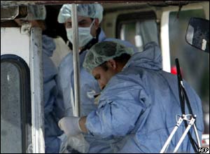 Bomb experts look for evidence in the bus 