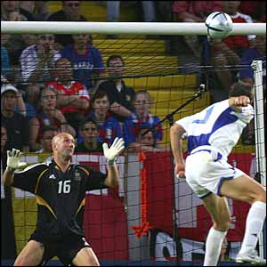 Angelos Charisteas powerfully heads towards the goal to score