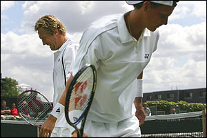 Jonas Bjorkman passes Joachim Johansson during a change over