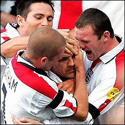 Michael owen is congratulated by England team-mates
