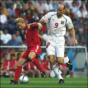 Christian Poulsen of Denmark battles with Jan Koller of the Czech Republic