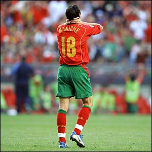 Portugal's Maniche holds his head in his hands after his shot goes narrowly wide